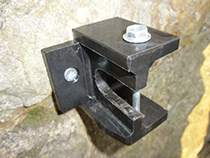 Plastic welded brackets for securing wheelie bins to a wall
